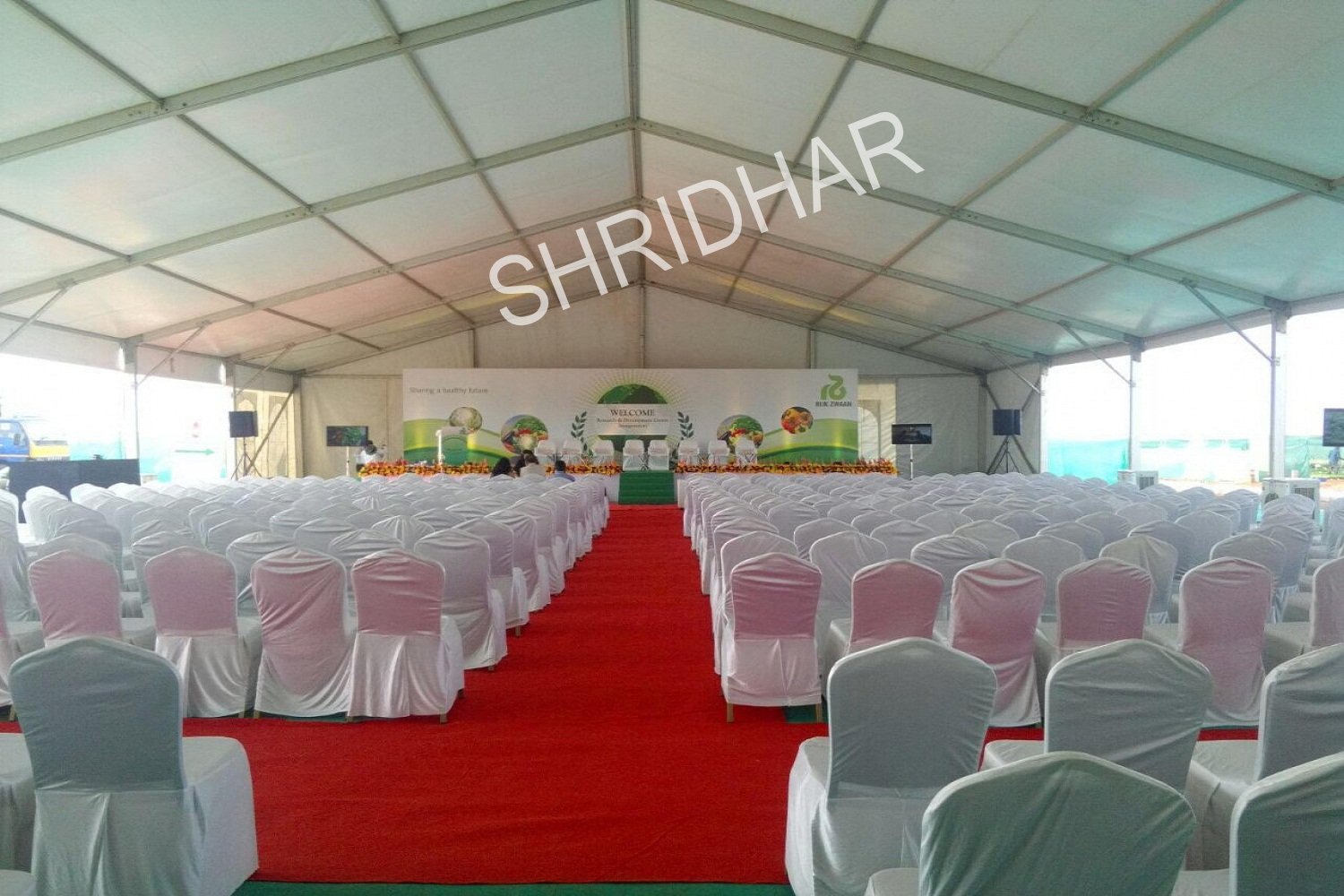 banquet chairs covered red synthetic carpets and wooden stages for rent for conferences in bangalore shridhar tent house